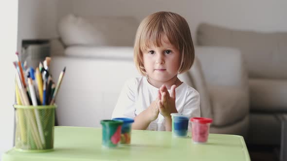 Portrait of Blond Girl Making Plasticine Figures at Home