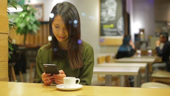 Woman Look at Cellphone at Indoor Cafe