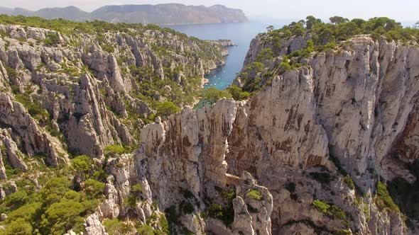 Aerial travel drone view of clear green water, cliffs of Cassis, Mediterranean Sea, Southern France.