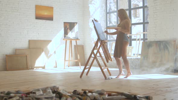 Oil Paints in Tubes Lie on the Table with Tassels in Art Workshop