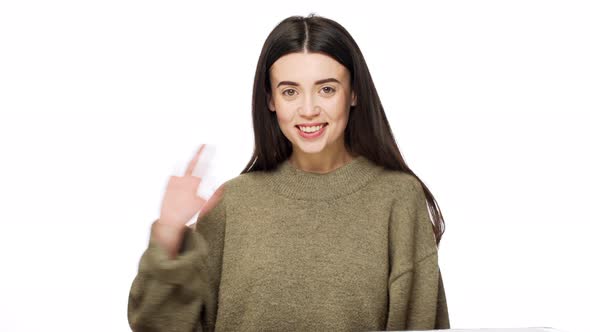 Portrait of Positive Brunette Woman with Long Hair Looking at Camera with Candid Smiling and Waving