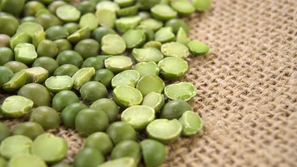 Organic dry split green peas on a rough rustic sackcloth