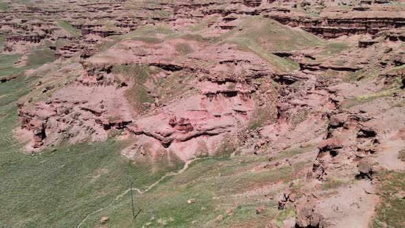 aerial red mountains and green valley