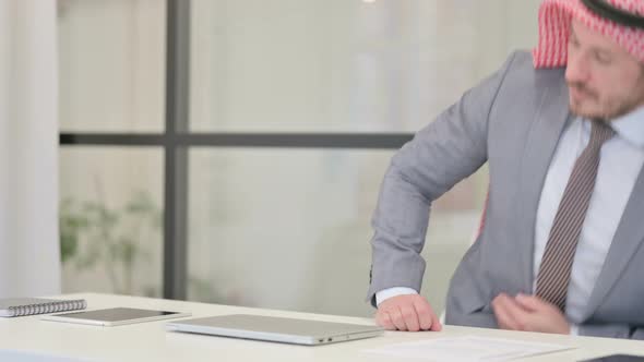 Middle Aged Arab Businessman Coming Back Opening Laptop in Office