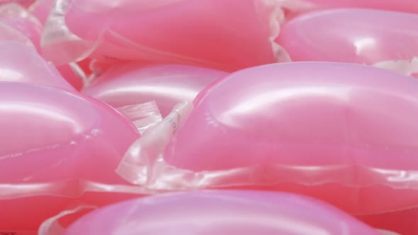 Modern  laundry washing pink capsule pile close-up 4K 2160p 30fps UHD tilting footage - Slow tilt ov alt