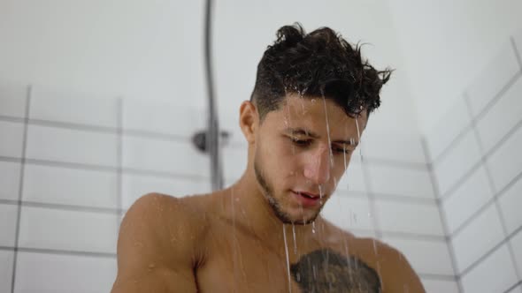 Handsome Man Taking Shower in Light Interior