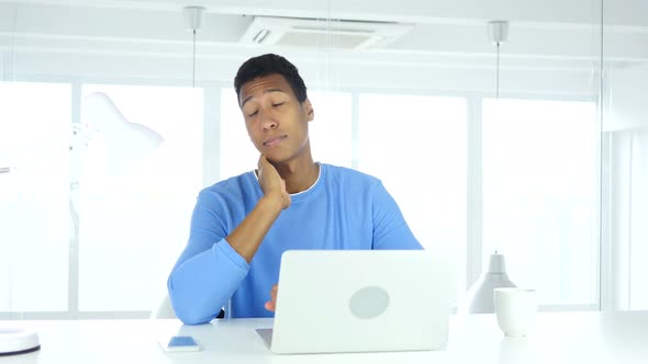 Tired Afro-American Man  Sitting at Work