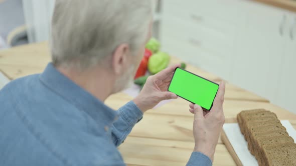 Rear View of Old Man Using Smartphone with Chroma Key Screen