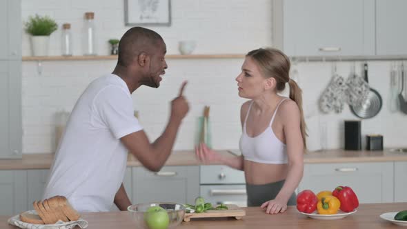 Athletic African Man Arguing with Young Woman in Kitchen