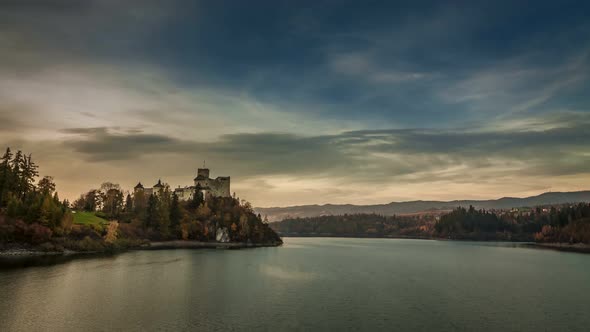 Niedzica castle by lake in autumn at sunset, Poland, Timelapse