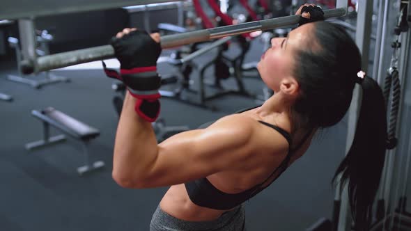 Strong Woman Doing Pull-ups in the Gym