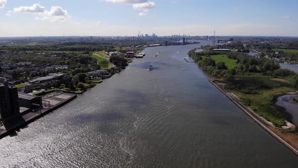 Skyscrapers And Green Field Surrounds The River In Kinderdijk Town In The Netherlands. aerial