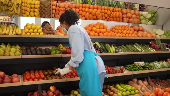 Masked Woman Working at Shelves in Supermarket