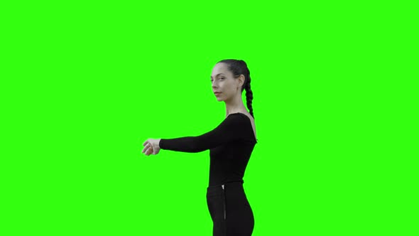 Young Woman Looking at her Watch with Green Screen.