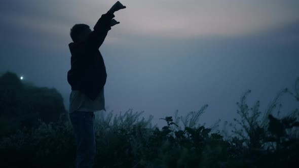 Guy Standing on Mountain Edge at Sunrise