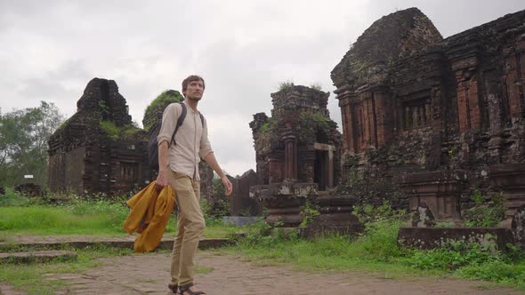 A Young Man Tourist Is Walking Through Ruins in the My Son Sanctuary Remains of an Ancient Cham