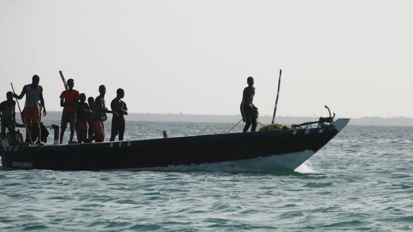 Funny Dancing African Fishermen on Wooden Motor Boat Floating By Ocean Africa