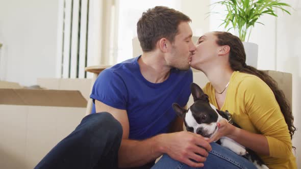 Happy caucasian couple in love hugging and kissing at home