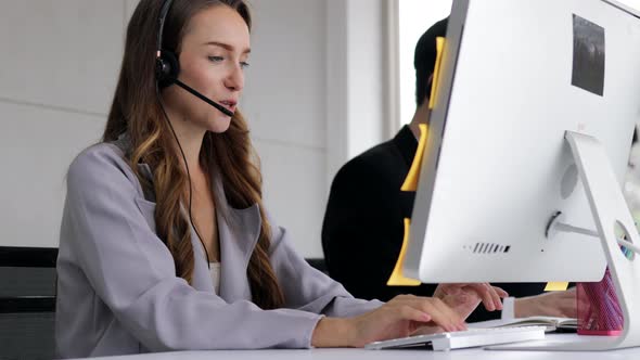 young beautiful women call center wear headset and working with computer while consulting customer
