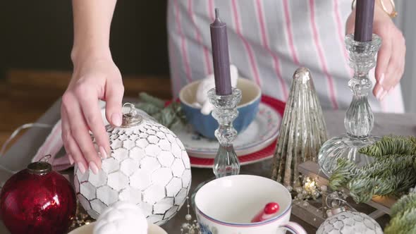 Christmas Table Decoration. Festive Table Setting. Female Hands Decorate the Table for Christmas