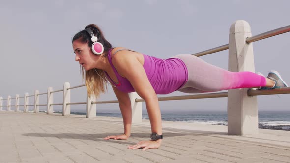 Caucasian woman working out on the docks