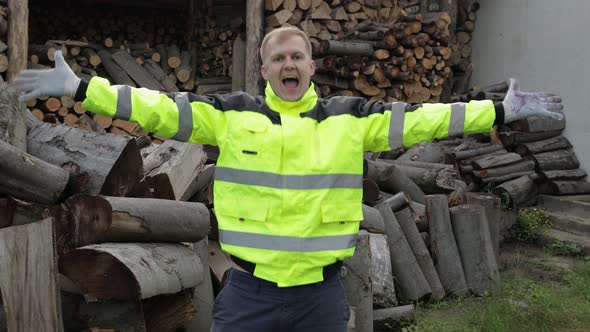 Lumberjack in Reflective Jacket. Man Woodcutter Dancing, Celebrate. Sawn Logs, Firewood Background