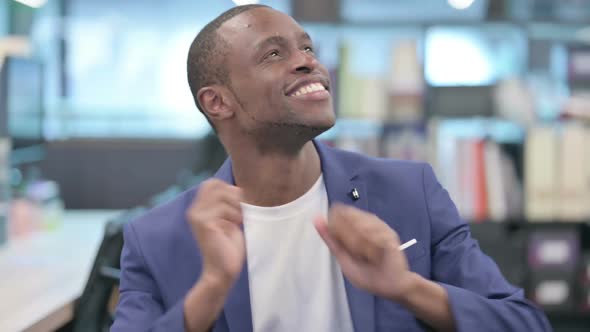 Portrait of African Businessman Dancing with Excitement