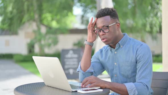 African Man with Laptop Having Headache