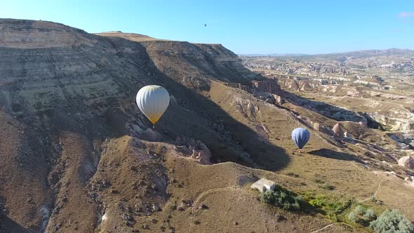 Aerial Hot Air Balloons Flying Over Hoodoos and Fairy Chimneys in Goreme Valley Cappadocia, Turkey