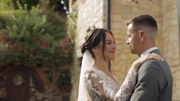 Lovely Newlyweds Caucasian Bride Embracing Groom in Park Making Kiss Wedding Couple Family Hugging