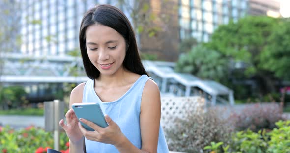 Chinese woman looking at mobile phone