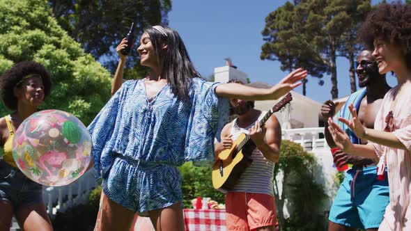 Diverse group of friends having fun and dancing at a pool party