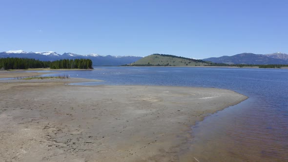 Flying low over sandbar on the shoreline of Hebgen Lake