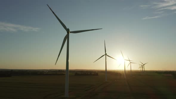 Aerial View of Wind Turbines Standing in a Wheat Field at Sunset