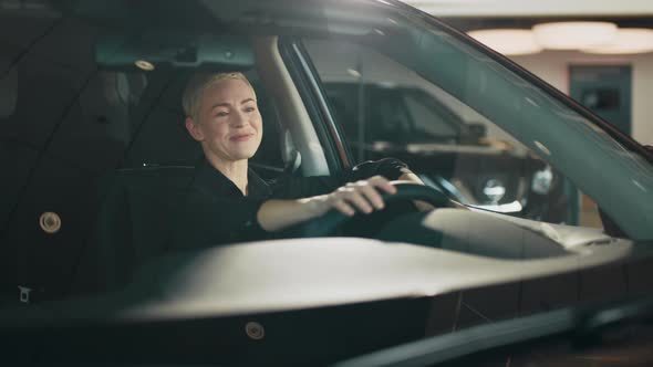 Cute Success Happy Woman is Driving a Car