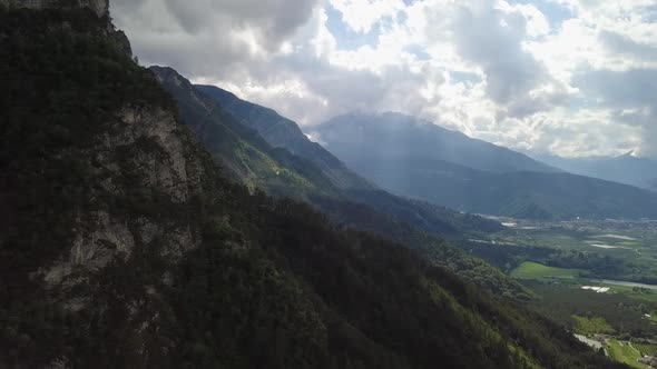 Aerial panoramic view of the mountains and valley in Borgo Valsugana, Trentino Italy with drone flyi