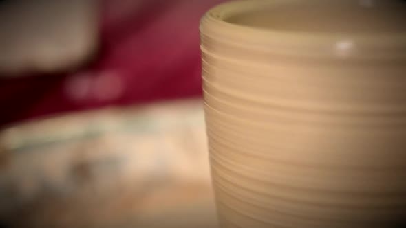 Raw Clay Jars Pots Stand and Turns Potter's Wheel in the Potter's Workshop Close