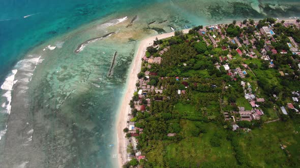 Birds eye view of a beautiful coastline with the incoming waves