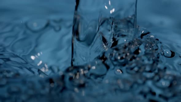 Blue Water and Continuous Pouring in Closeup Motion