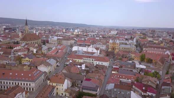 Drone shot flying above the center of Cluj in Romania on a sunny day