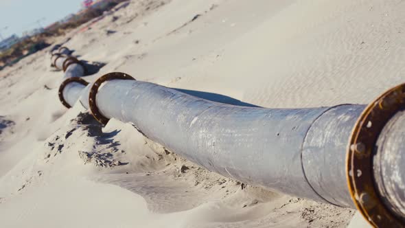 A Long Tube on the Sand of the Beach