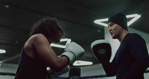 Handsome African Guy is Training in Boxing Club Practicing Punches with Coach  Prores