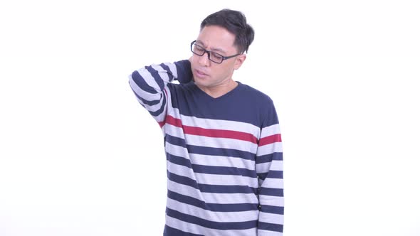 Stressed Japanese Hipster Man with Eyeglasses Having Neck Pain