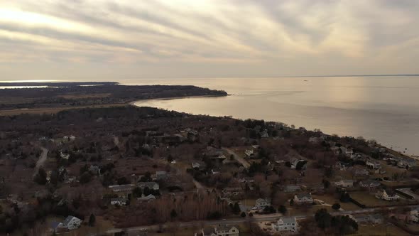 an aerial view over the eastern end of Orient Point, Long Island during sunset. The camera truck lef