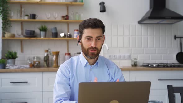 Man Teacher Tutor Coach Talking to Web Camera on Laptop Holding Online Lesson