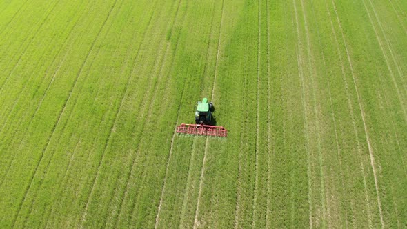 Aerial view of tractor cultivating field