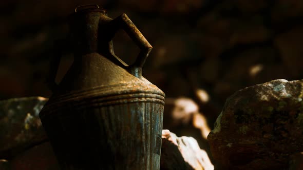 Old Metal Jug at Rocks alt