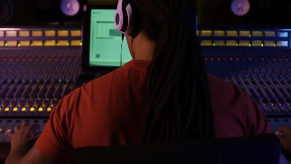 Male sound engineer working at a mixing desk