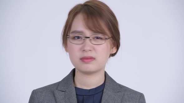 Face of Young Serious Asian Businesswoman Nodding Head No