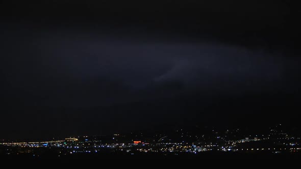 Thunderstorm in Night Illuminated City